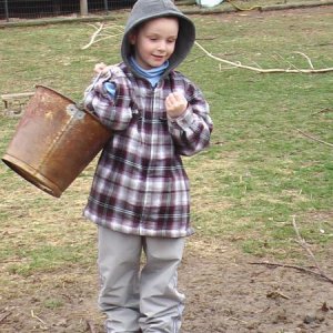 My boy feeding chickens, notice how bare the ground is