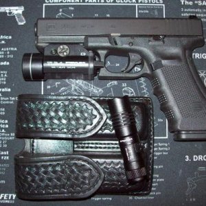 Glock 22 Gen.4 w/Streamlight TLR-1 tac light  /  PT-1L flashlight and Aker 510 double mag pouch.

This is what is on my nightstand.