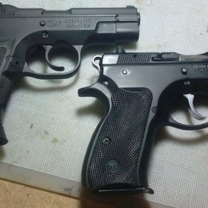 Armalite AR-24Kc and a CZ 75 Compact.