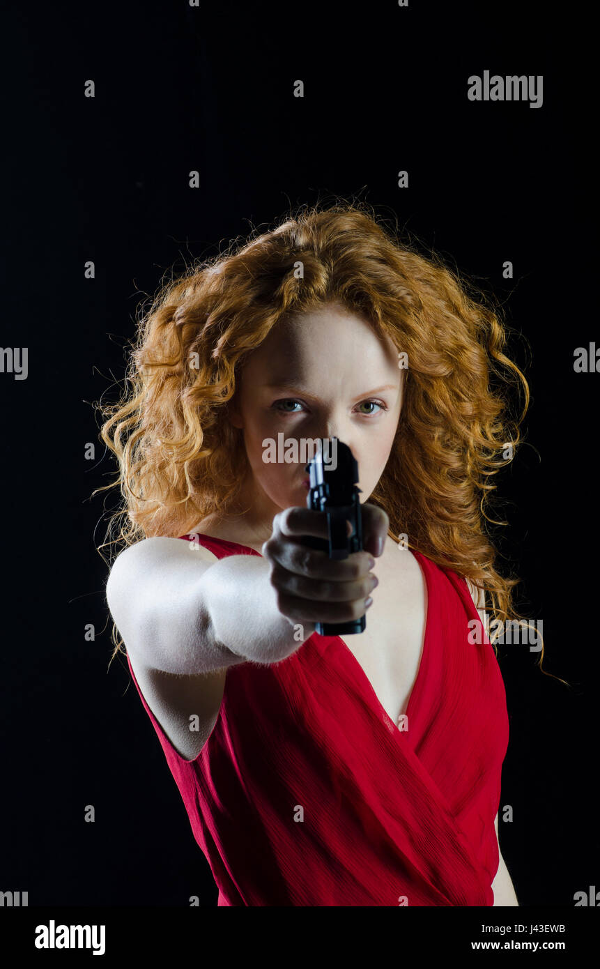 dangerous-redhead-woman-aiming-a-gun-J43EWB.jpg