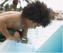 Image of a small child stepping into a pool